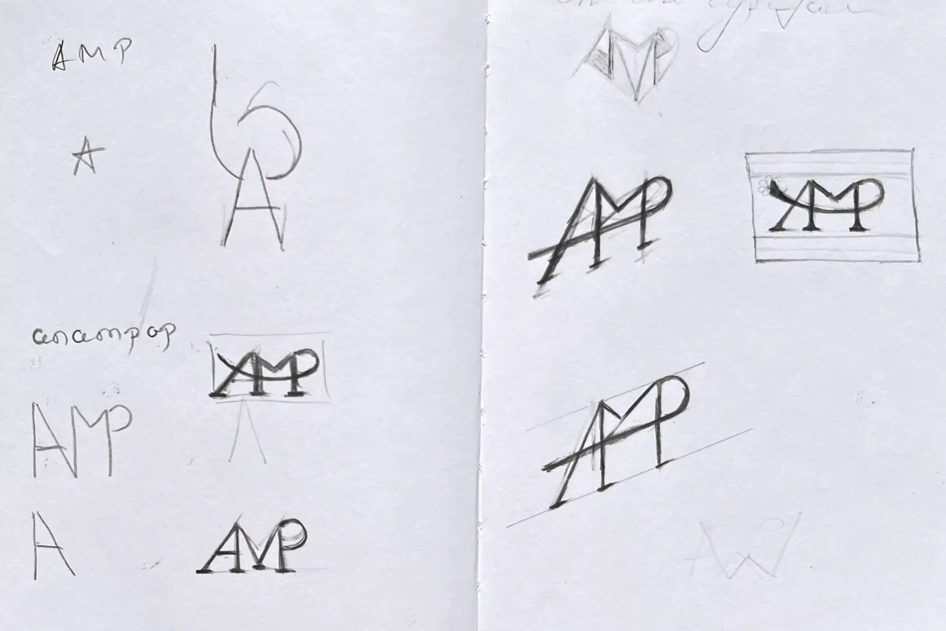 Hand-drawn logo sketches for AMP in a notebook, exploring monogram concepts and geometric variations.